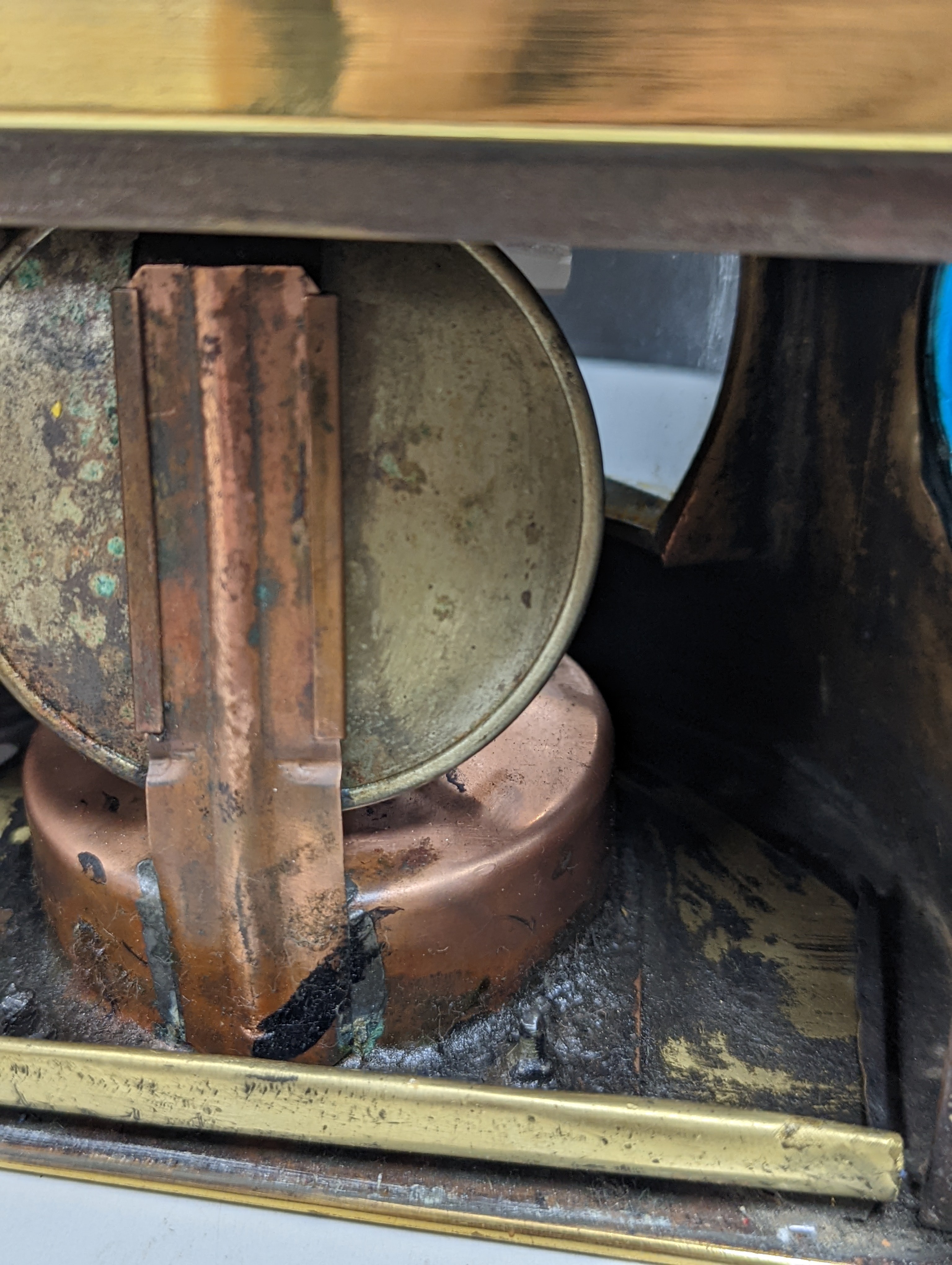 A copper ship's binnacle compass, a brass oil lamp, a brass jug and a copper kettle